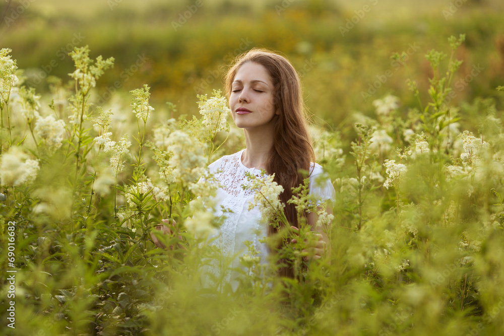 Happy woman with eyes closed among the wildflowers Happy woman with eyes closed among the wildflowers