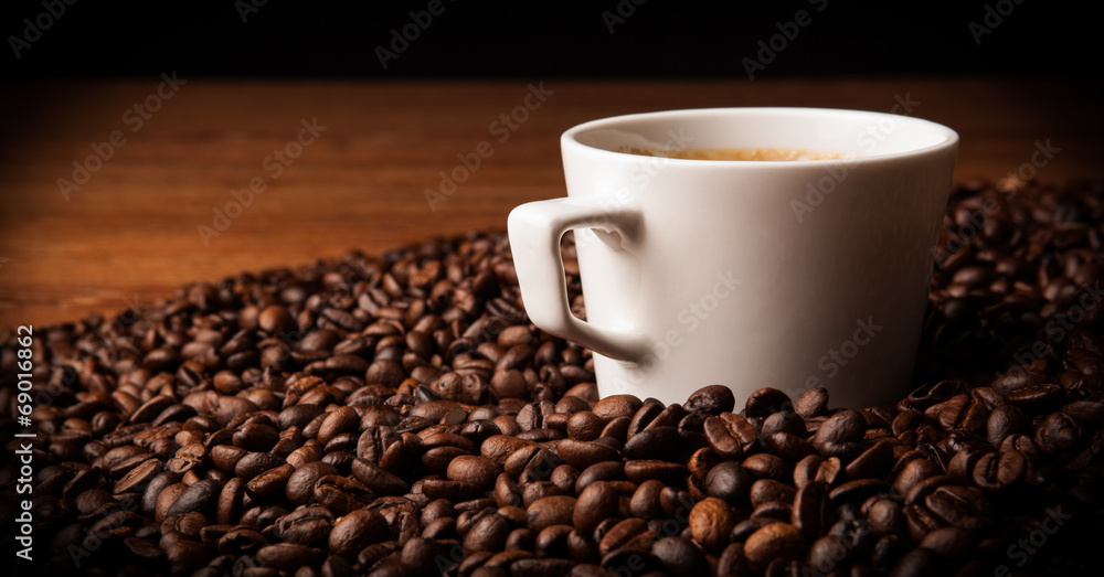 cup of black coffee with roasted coffe beans cup of black coffee with roasted coffe beans