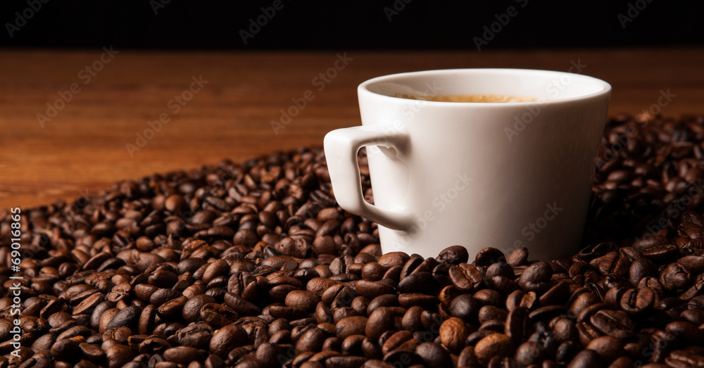 cup of black coffee with roasted coffe beans cup of black coffee with roasted coffe beans