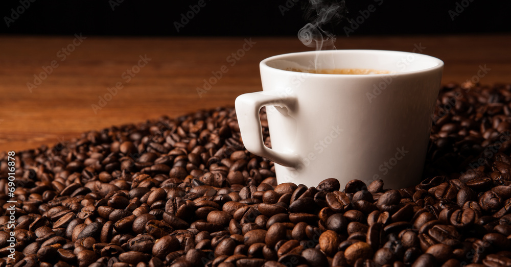cup of black coffee with roasted coffe beans cup of black coffee with roasted coffe beans