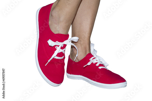 Female feet in red gym shoes