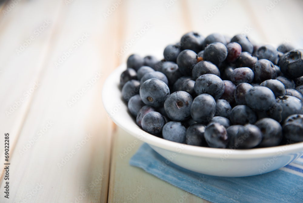fresh blueberries ion white plate on kitchen table fresh blueberries ion white plate on kitchen table