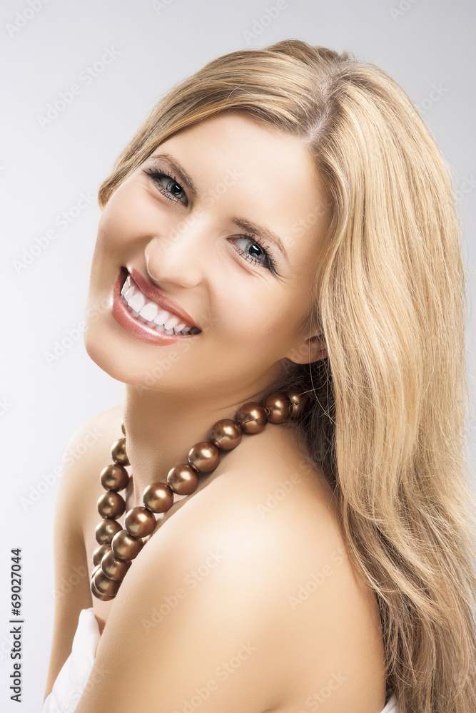 Beauty Concept: Portrait of Smiling Caucasian Blond Woman Over G