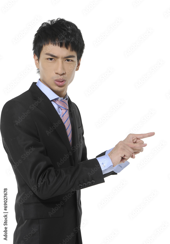 Young business man in suit pointing at copy space Young business man in suit pointing at copy space