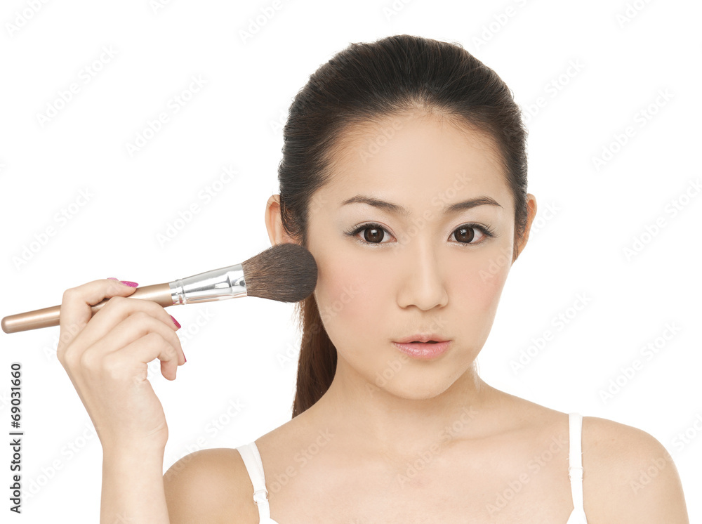 beautiful woman holding makeup brush over white beautiful woman holding makeup brush over white