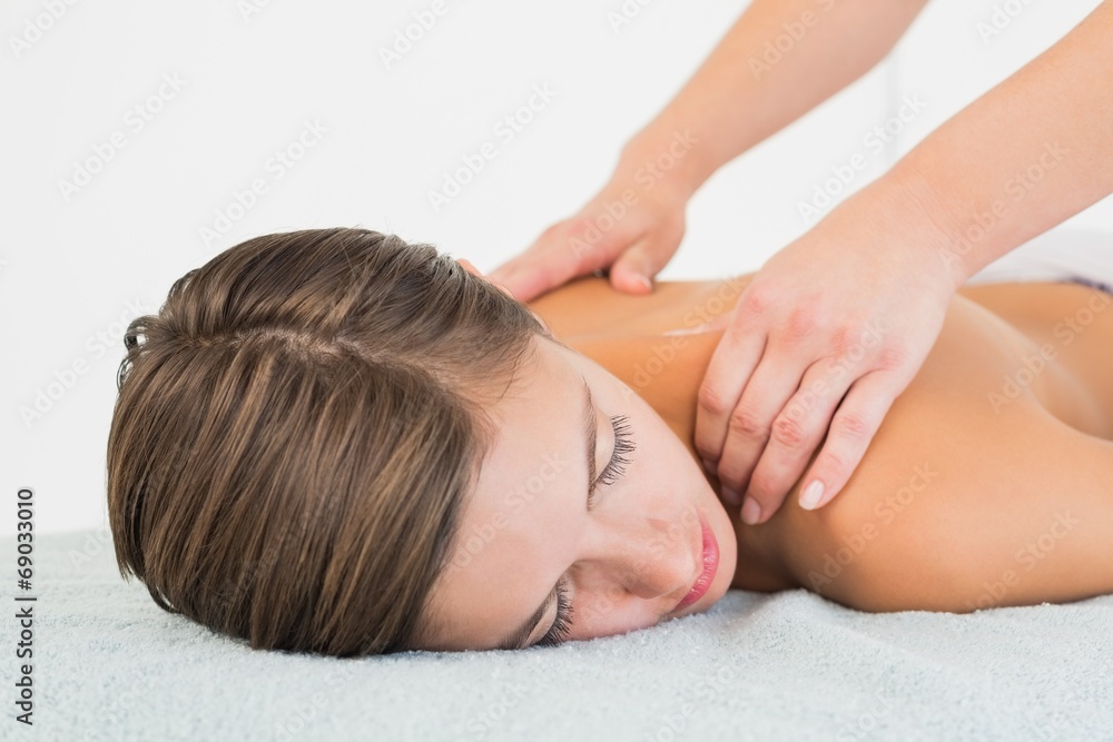 Attractive young woman receiving shoulder massage Attractive young woman receiving shoulder massage