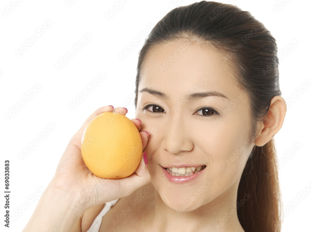 Portrait of beautiful woman, she holding fresh orange Portrait of beautiful woman, she holding fresh orange
