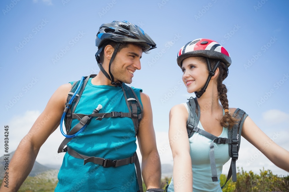 Athletic couple mountain biking Athletic couple mountain biking