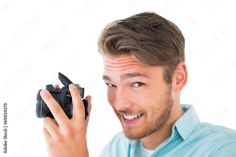 Handsome young man holding digital camera Handsome young man holding digital camera