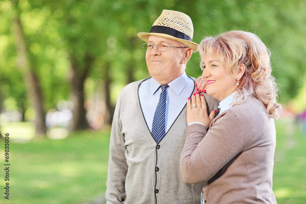 Lovely mature couple standing in park Lovely mature couple standing in park