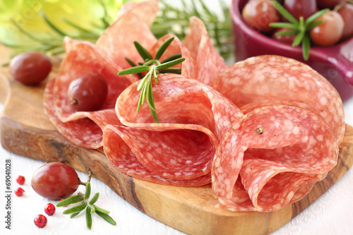 Salami with fresh rosemary sprigs and olives