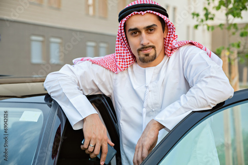 Young Arabian Next To Car photo