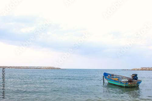 Small fishing wooden boat in the sea © kannapon