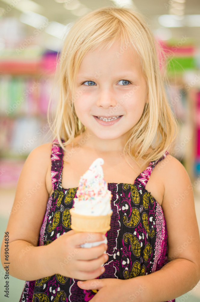 Adorable girl eat fruit ice cream in mall Adorable girl eat fruit ice cream in mall