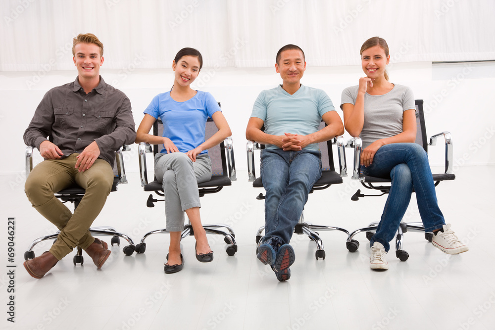 Multi ethnic group of people sitting office chair