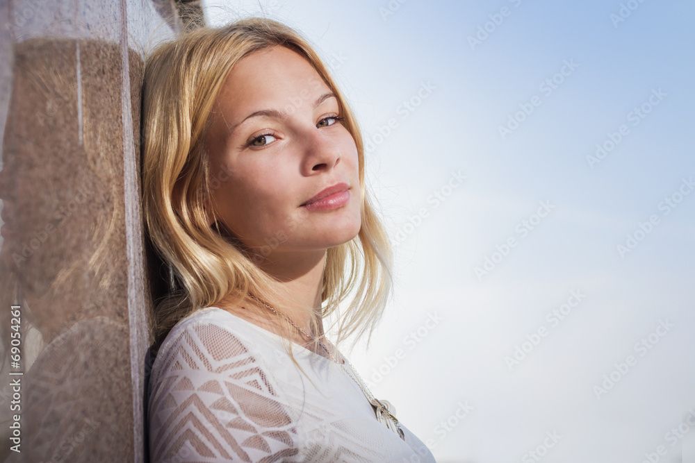 The beautiful girl costs at a wall having nestled The beautiful girl costs at a wall having nestled