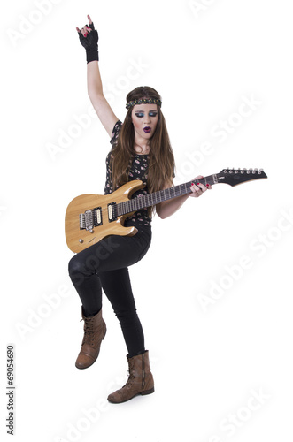 Young pretty blond rocker girl playing electric guitar