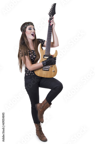 Young pretty blond rocker girl playing electric guitar