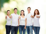smiling teenagers in t-shirts showing thumbs up