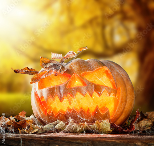 Scary hallowen pumpkin on wood photo