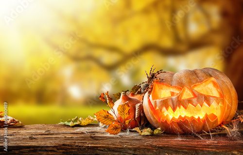 Scary hallowen pumpkins on wood photo