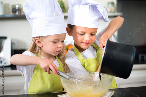 happy children kids family preparing funny cake kitchen at home