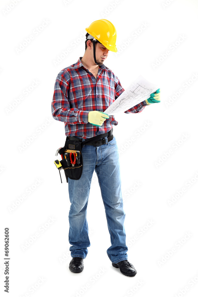 Male construction worker examining blueprint Male construction worker examining blueprint