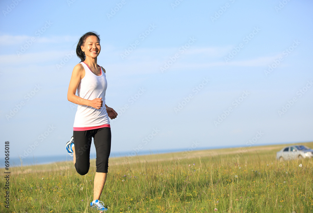 Runner athlete legs running on seaside grassland Runner athlete legs running on seaside grassland