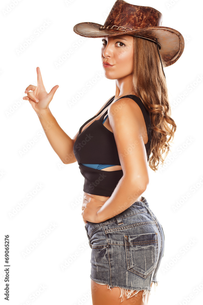 woman with a cowboy hat posing with a finger up woman with a cowboy hat posing with a finger up