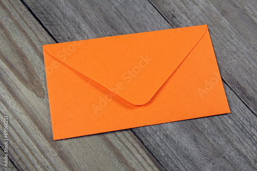 orange envelope on wooden background