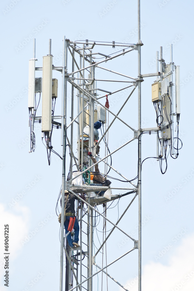 Technician working on communication towers Technician working on communication towers