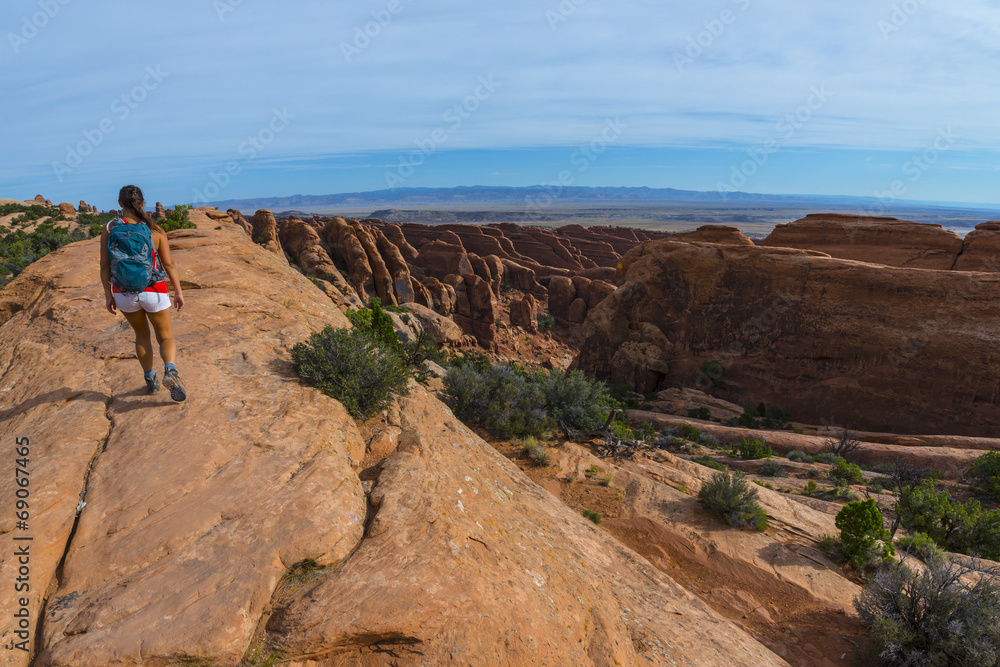 Female hiker on a Devils Garden trail to Double O Arch Female hiker on a Devils Garden trail to Double O Arch
