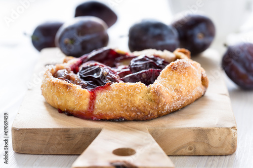 Homemade plum galette on wooden board