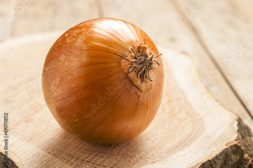 Onion on wooden background close up