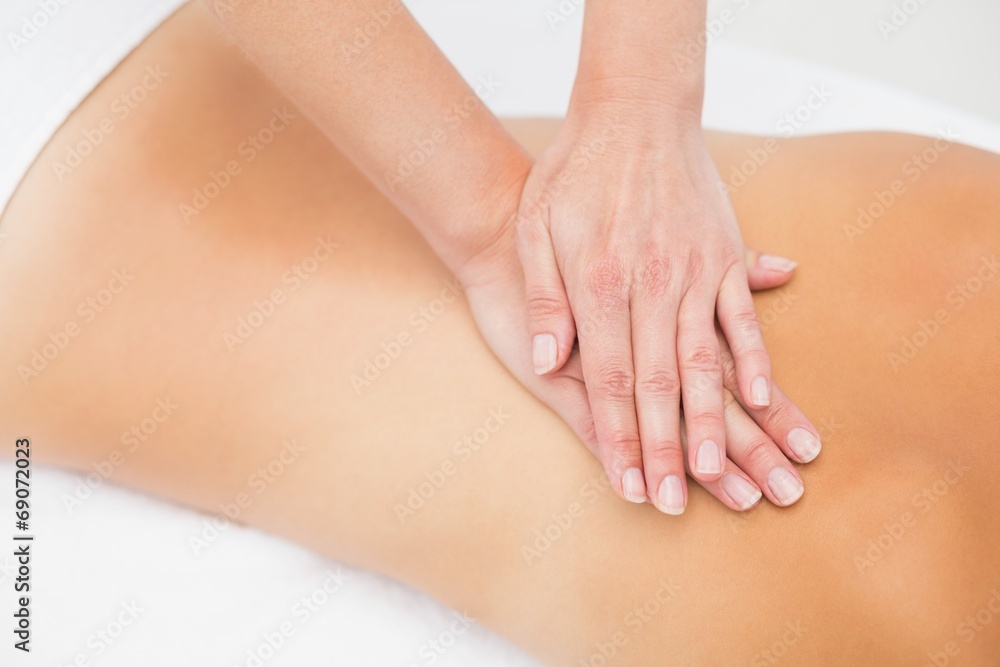 Woman receiving back massage at spa center Woman receiving back massage at spa center