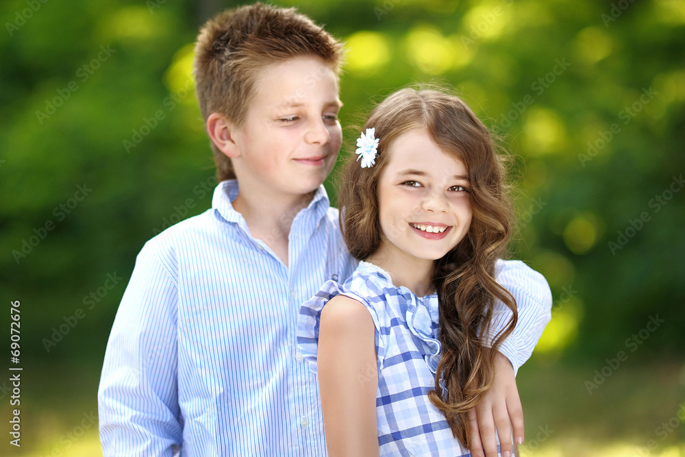 Fototapeta premium Portrait of a boy girl in a summer
