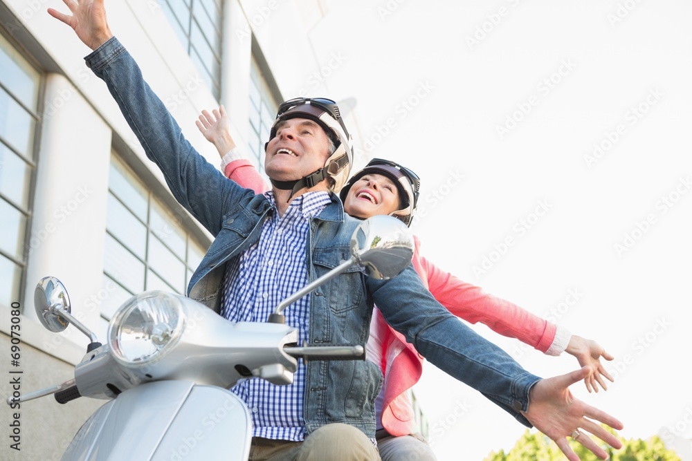 © WavebreakmediaMicro - Happy senior couple riding a moped