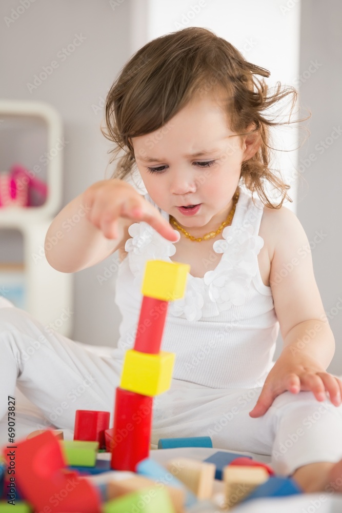 Cute girl playing with building blocks on bed Cute girl playing with building blocks on bed