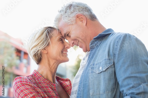 Happy mature couple hugging in the city