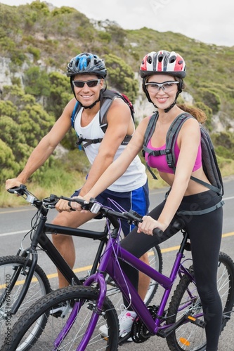 Athletic couple mountain biking