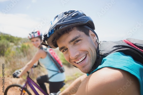 Athletic couple mountain biking