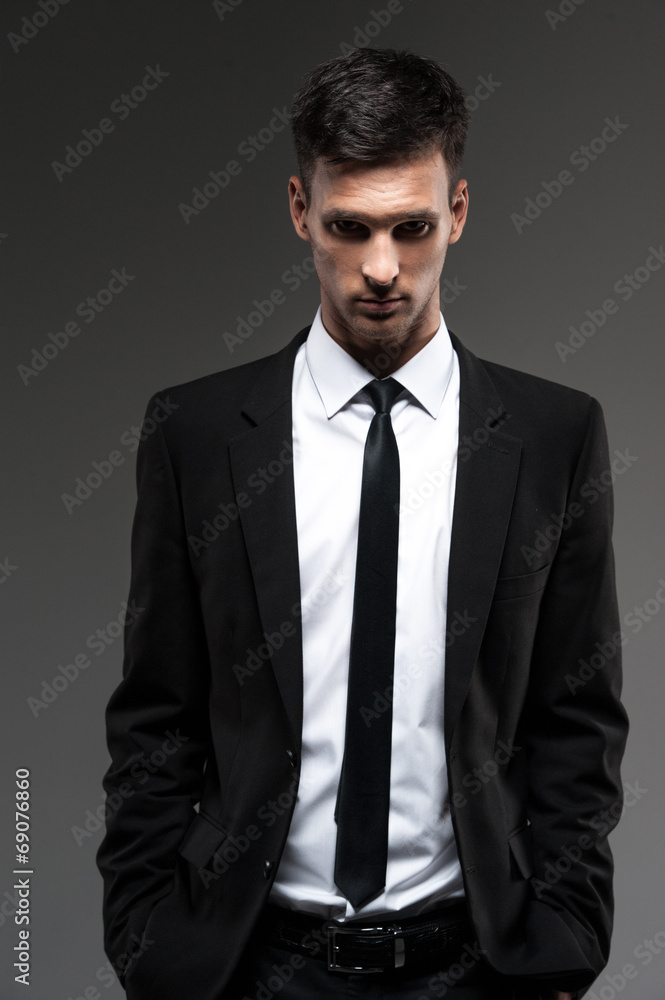 Handsome young man on grey background. Handsome young man on grey background.