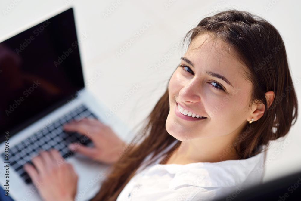 relaxed young woman at home working on laptop computer relaxed young woman at home working on laptop computer