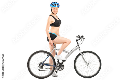 Profile shot of a female cyclist sitting on a bike