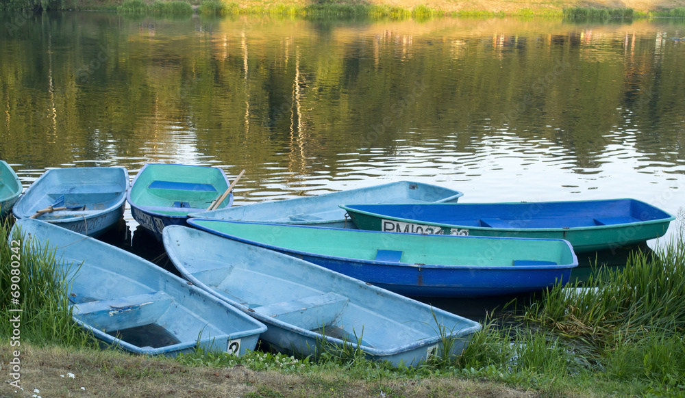Boats on the shore of the city pond