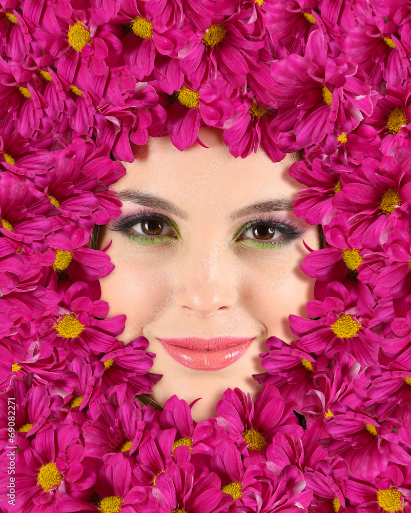 Woman beauty face with beautiful flowers frame, close-up Woman beauty face with beautiful flowers frame, close-up