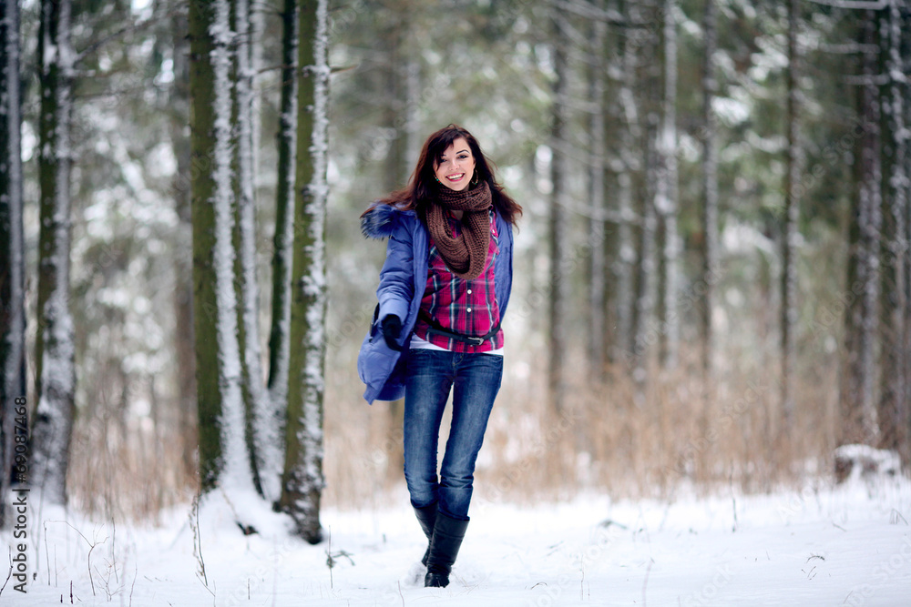 brunette girl running in a snowy forest brunette girl running in a snowy forest