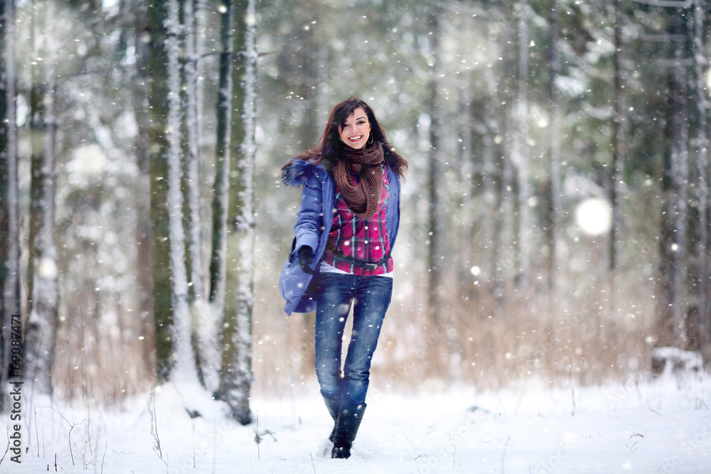 brunette girl running in a snowy forest brunette girl running in a snowy forest
