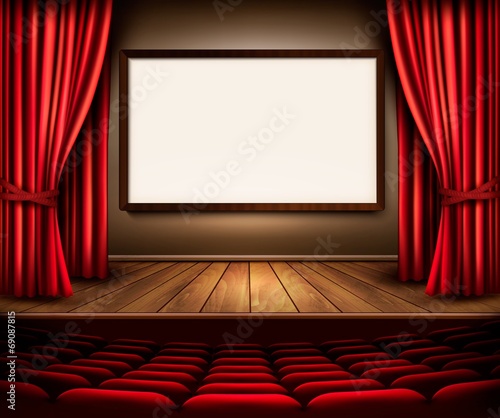 A theater stage with a red curtain, seats and a project board. V