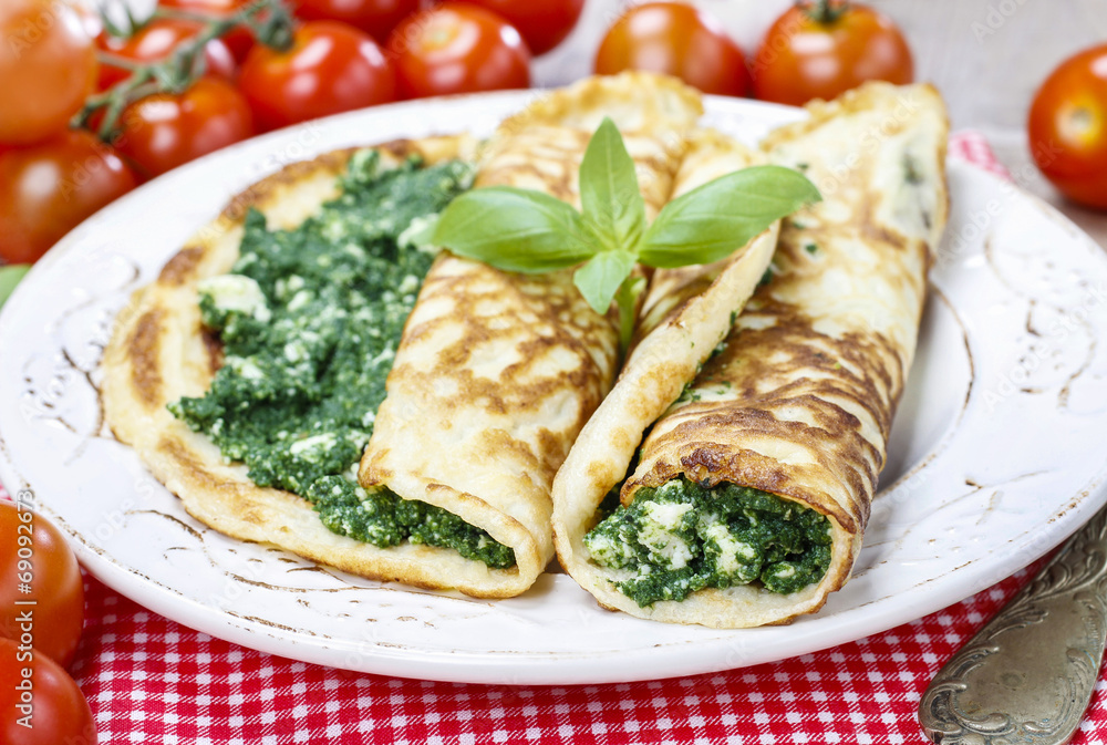 Mediterranean cuisine: crepes stuffed with cheese and spinach Mediterranean cuisine: crepes stuffed with cheese and spinach
